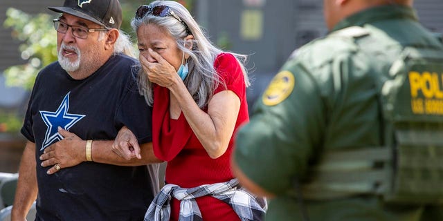 A woman cries as she leaves the Uvalde Civic Center, Tuesday May 24, 2022, in Uvalde, Texas.