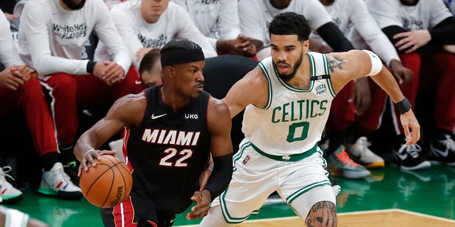 Miami Heat's Jimmy Butler drives past the Celtics' Jayson Tatum during the Eastern Conference finals Saturday, May 21, 2022, in Boston.