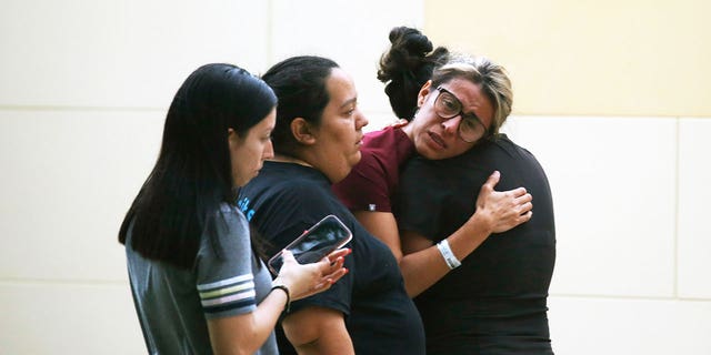 People react outside the Civic Center following a deadly school shooting at Robb Elementary School in Uvalde, Texas Tuesday, May 24, 2022.