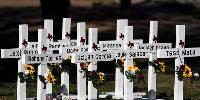 Crosses with the names of Tuesday's shooting victims are placed outside Robb Elementary School in Uvalde, Texas, Thursday, May 26, 2022. (AP Photo/Jae C. Hong)