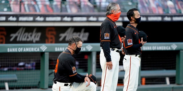 Manager Gabe Kapler #19 of the San Francisco Giants kneels during the playing of the National Anthem prior to their game against the Texas Rangers at Oracle Park on August 01, 2020 in San Francisco, California. 