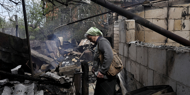 Vera Kosolopenko reacts outside her destroyed house in the village of Bezruky, near Derhachi, Ukraine, on May 14 after it was hit by Russian shelling.