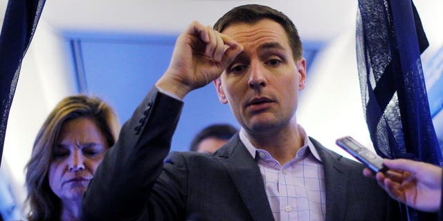 Robby Mook, Campaign Manager for U.S. Democratic presidential nominee Hillary Clinton, and Communications Director Jen Palmieri (L), talk to reporters onboard the campaign plane enroute to Cedar Rapids, Iowa, U.S. October 28, 2016.