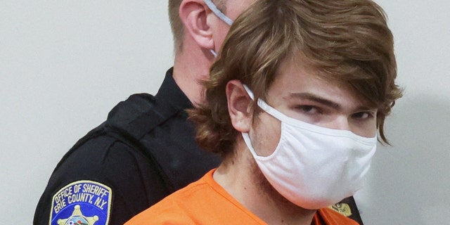 Buffalo shooting suspect, Payton S. Gendron, who is accused of killing 10 people in a live-streamed supermarket shooting in a Black neighborhood of Buffalo, is escorted in the courtroom in shackles, in Buffalo, New York, U.S., May 19, 2022.