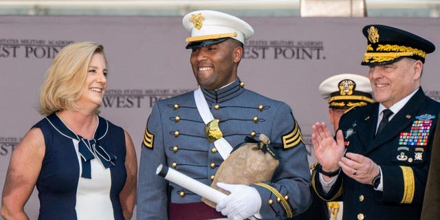 U.S. Military Academy graduating cadet Isaac Jefferson Dixon IV from Oceanside, CA is applauded by U.S. Army General Mark A. Milley, chairman of the Joint Chiefs of Staff, next to Christine Wormuth, Secretary of the Army, during the U.S. Military Academy's Class of 2022 graduation ceremony at West Point, New York, May 21, 2022. 