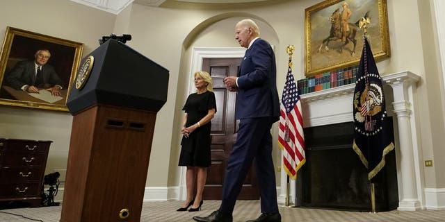 U.S. first lady Jill Biden looks on as U.S. President Joe Biden approaches the lectern to make a statement about the school shooting in Uvalde, Texas shortly after the president returned to Washington from his trip to South Korea and Japan, at the White House in Washington, U.S. May 24, 2022. REUTERS/Kevin Lamarque