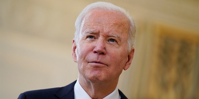 President Biden listens to a reporter's question at the White House, Dec. 3, 2021.