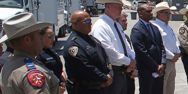 Uvalde School Police Chief Pete Arredondo, third from left, stands during a news conference outside of the Robb Elementary school in Uvalde, Texas. The local police and school district police have reportedly stopped cooperating with state investigators into the mass shooting and a review into the police response.