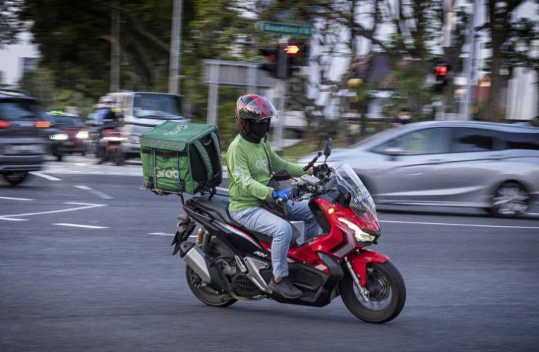 Singapore’s Grab cuts losses as region lifts pandemic restrictions