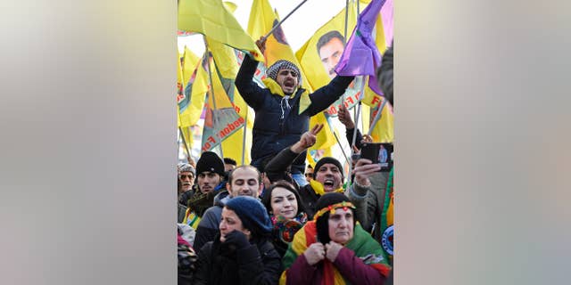 Pro-Kurdish  demonstrators protest  against Turkish president Recep Tayyip Erdogan and the political repression that followed July's failed military coup,  in Cologne, Germany Saturday, Nov. 12, 2016. People showing flags of detained Kurdistan Workers Party, PKK , leader Abdullah Ocalan. (AP Photo/Martin Meissner)