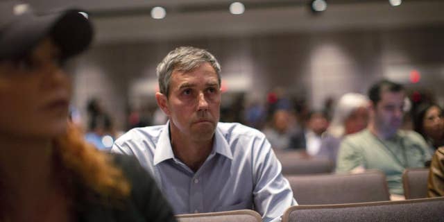 Texas Democrat gubernatorial candidate Beto O'Rourke listens before interrupting a news conference headed by Texas Gov. Greg Abbott in Uvalde, Texas Wednesday, May 25, 2022. 