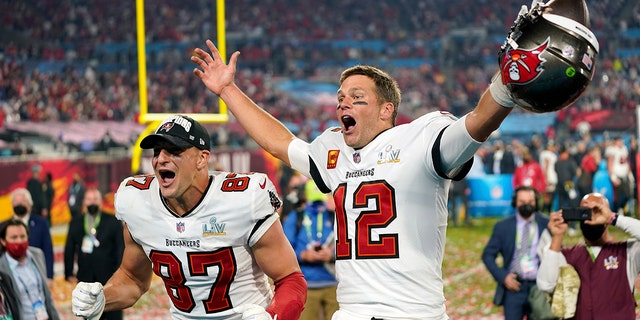 FILE - In this Sunday, Feb. 7, 2021 file photo, Tampa Bay Buccaneers tight end Rob Gronkowski (87), left, and Tampa Bay Buccaneers quarterback Tom Brady (12) celebrate together after Super Bowl 55 football game against the Kansas City Chiefs in Tampa, Fla.