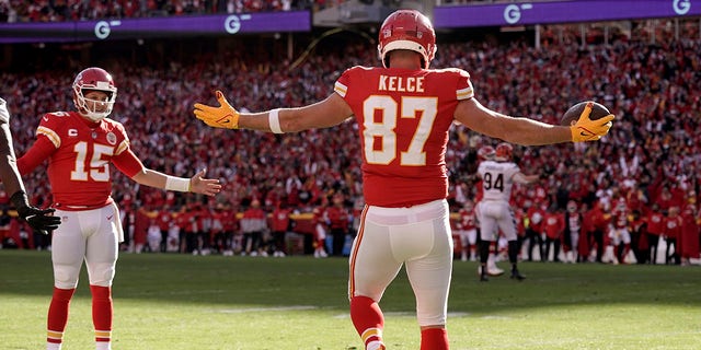 Kansas City Chiefs tight end Travis Kelce (87) celebrates after catching a 5-yard touchdown pass from quarterback Patrick Mahomes (15) during the first half of the AFC championship NFL football game against the Cincinnati Bengals, Sunday, Jan. 30, 2022, in Kansas City, Mo.