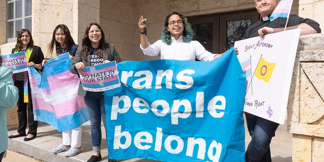 IMAGE DISTRIBUTED FOR HUMAN RIGHTS CAMPAIGN - Adri Perez, ACLU of Texas Policy and Advocacy Strategist, center, and other LGBTQ leaders speak outside the Travis County courthouse where a hearing was held to stop the newly mandated cruel and unconstitutional child welfare investigations targeting supportive families of transgender children, on Wednesday, Mar. 02, 2022 in Austin. (Erich Schlegel/AP Images for Human Rights Campaign)