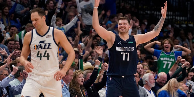 Dallas Mavericks guard Luka Doncic (77) celebrates behind Utah Jazz forward Bojan Bogdanovic (44) after scoring during the second half of Game 5 of an NBA basketball first-round playoff series, Monday, April 25, 2022, in Dallas. 