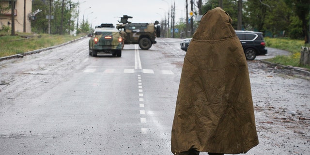 A serviceman of Donetsk People's Republic militia stands guard not far from the besieged Mariupol's Azovstal steel plant in Mariupol, in territory under the government of the Donetsk People's Republic, eastern Ukraine, Wednesday, May 18, 2022. (AP Photo)