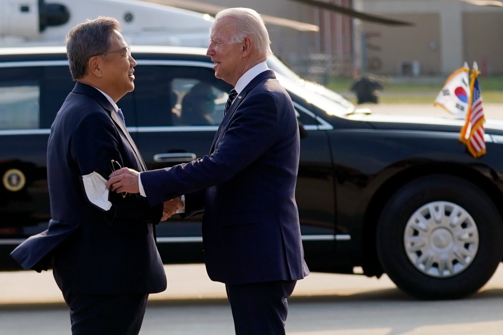 South Korean Foreign Minister Park Jin greets U.S.President Joe Biden as he arrives at Osan Air Base, Friday, May 20, 2022, in Pyeongtaek, South Korea.