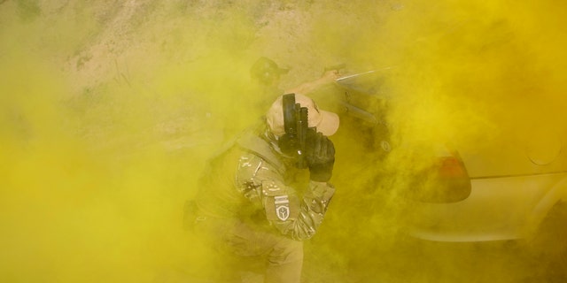 Volunteers from Belarus practice at a shooting range near Warsaw, Poland, Friday, May 20, 2022. The fighters from Belarus are improving their military skills in Poland before deploying to Ukraine, where they plan to join a legion of foreign fighters defending Ukraine against Russian attacks. 