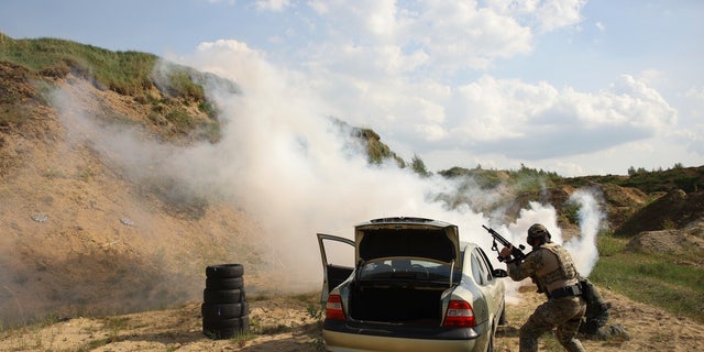 Volunteers from Belarus practice at a shooting range near Warsaw, Poland, on Friday, May 20, 2022. Belarusians are among the foreign fighters who have volunteered to take up arms in Ukraine against Russian forces. They consider the Ukrainians defending their homeland to be their brethren. And by joining their resistance to Russia's onslaught, they hope to weaken the rule of Russian President Vladimir Putin, and ultimately that of Belarus President Alexander Lukashenko.