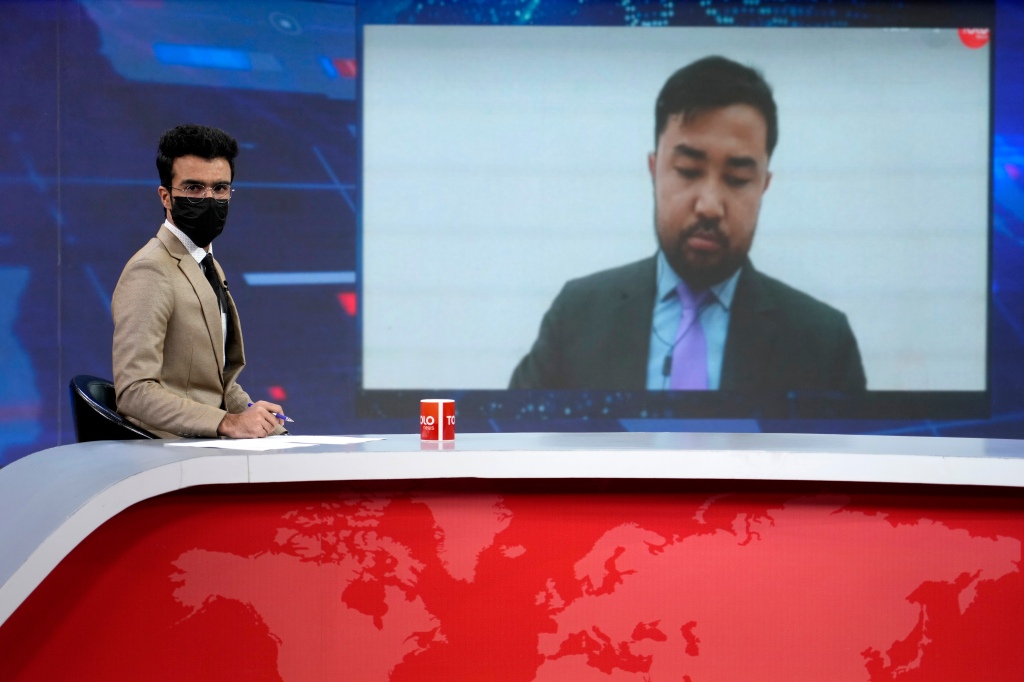 TV anchor Hamed Bahram wears a face mask to protest the Taliban's new order that female presenters cover their faces.