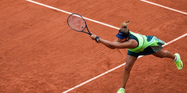 Japan's Naomi Osaka plays a shot against Amanda Anisimova of the U.S. during their first round match at the French Open tennis tournament in Roland Garros stadium in Paris, France, Monday, May 23, 2022. 