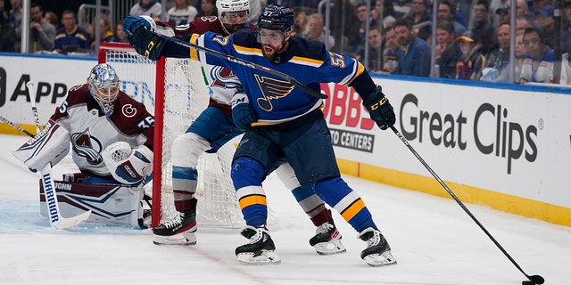 Blues' David Perron handles the puck as Colorado Avalanche goaltender Darcy Kuemper and Nazem Kadri defend during Game 4 of the Stanley Cup playoff series Monday, May 23, 2022, in St. Louis.