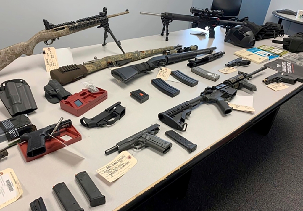 Velasquez, a disgruntled ex-worker, was charged with cyberstalking co-workers and police seized his arsenal of weapons.