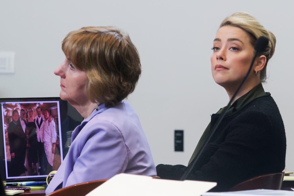 Actor Amber Heard and her attorney Elaine Bredehoft listen to actor Johnny Depp's testimony in the courtroom
