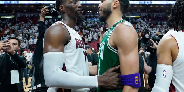 Miami Heat center Bam Adebayo (13) congratulates Boston Celtics forward Jayson Tatum (0) after the Celtics won Game 7 of the NBA basketball Eastern Conference finals playoff series, Sunday, May 29, 2022, in Miami.