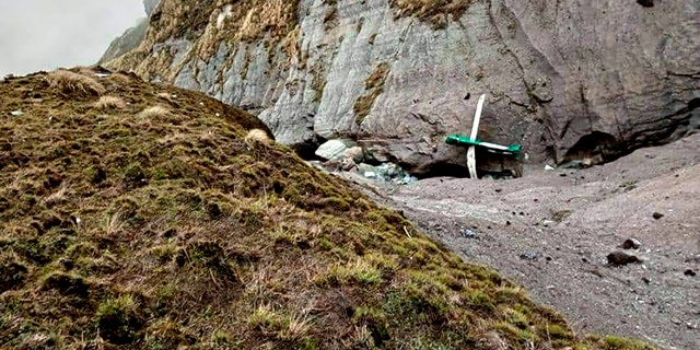 This handout photograph released by Fishtail Air, shows the wreckage of a plane in a gorge in Sanosware in Mustang district close to the mountain town of Jomsom, west of Kathmandu, Nepal, Monday, May 30, 2022. The wreckage of a plane carrying 22 people that disappeared in Nepal's mountains was found Monday scattered on a mountainside, the army said. There was no word on survivors. (Fishtail Air via AP)