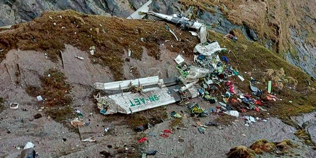 This handout photograph released by Fishtail Air, shows the wreckage of a plane in a gorge in Sanosware in Mustang district close to the mountain town of Jomsom, west of Kathmandu, Nepal, Monday, May 30, 2022. The wreckage of a plane carrying 22 people that disappeared in Nepal's mountains was found Monday scattered on a mountainside, the army said. There was no word on survivors. (Fishtail Air via AP)