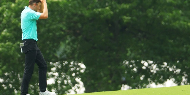 Aaron Wise of the U.S. reacts on the seventh hole after being hit by a ball from Cameron Smith of Australia during the second round of the 2022 PGA Championship at Southern Hills Country Club May 20, 2022, in Tulsa, Okla.