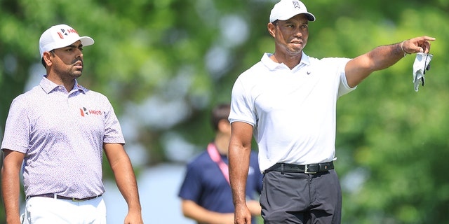 Anirban Lahiri walks up the seventh fairway with Tiger Woods during practice for the 2022 PGA Championship at Southern Hills Country Club on May 18, 2022, in Tulsa, Oklahoma.