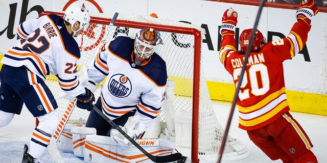 Edmonton Oilers goalie Mikko Koskinen, center, reacts as Calgary Flames forward Blake Coleman celebrates his goal during the second period of Game 1 of an NHL hockey second-round playoff series Wednesday, May 18, 2022, in Calgary, Alberta. 