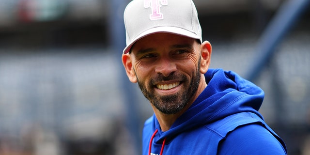 Manager Chris Woodward #8 of the Texas Rangers looks on prior to the game between the Texas Rangers and the New York Yankees at Yankee Stadium on Sunday, May 8, 2022, in New York, New York.