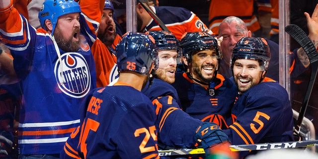 Edmonton Oilers winger Evander Kane, second right, celebrates his goal with teammates during the second period of an NHL hockey Stanley Cup second-round playoff series game in Edmonton, Alberta, Sunday, May 22, 2022.