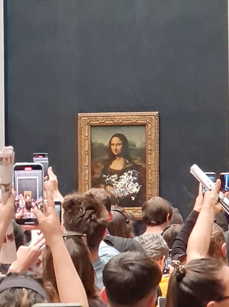 Other footage shows the protester being wrestled out of the famed museum in front of Mona Lisa's undamaged famous smile.