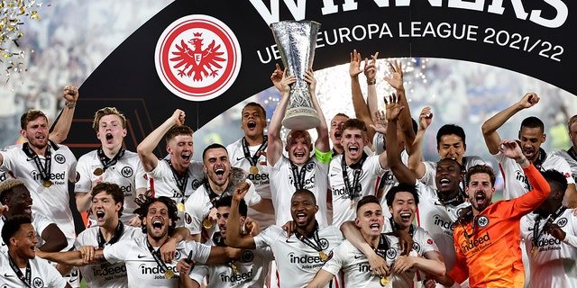 Frankfurt players lift the trophy for winners of the Europa League final soccer match between Eintracht Frankfurt and Rangers FC at the Ramon Sanchez Pizjuan stadium in Seville, Spain, Thursday, May 19, 2022. 