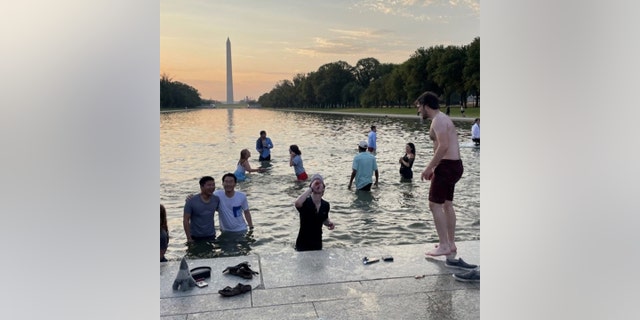 Georgetown University students took a dip in the Reflecting Pool on the National Mall in Washington, D.C., Saturday, May 21, 2022.