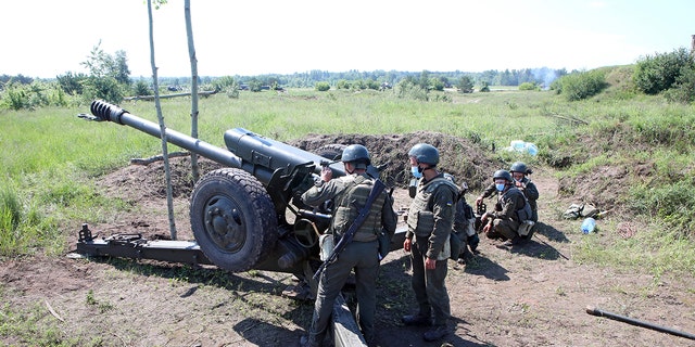 Soldiers man a howitzer during artillery drills of the Eastern Operational-Territorial Command of the National Guard of Ukraine, Kharkiv Region, northeastern Ukraine. 