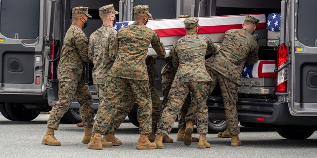 A U.S. Marine Corps carry team transfers the remains of Marine Corps Cpl. Humberto A. Sanchez of Logansport, Ind., Aug. 29, 2021 at Dover Air Force Base in Delaware. 