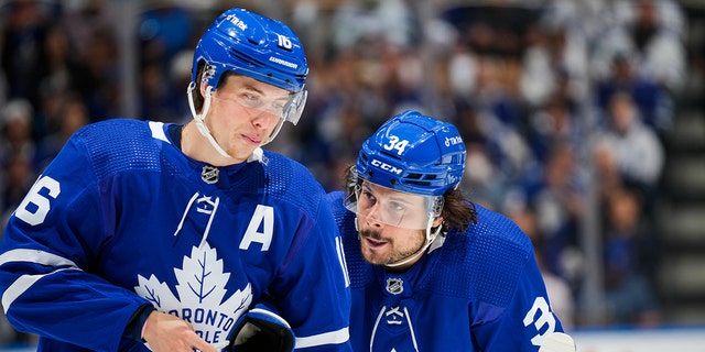 Auston Matthews, right, of the Toronto Maple Leafs, talks with teammate Mitch Marner (16) during Game 7 of the first round of the 2022 Stanley Cup playoffs against the Tampa Bay Lightning at Scotiabank Arena May 14, 2022, in Toronto. 