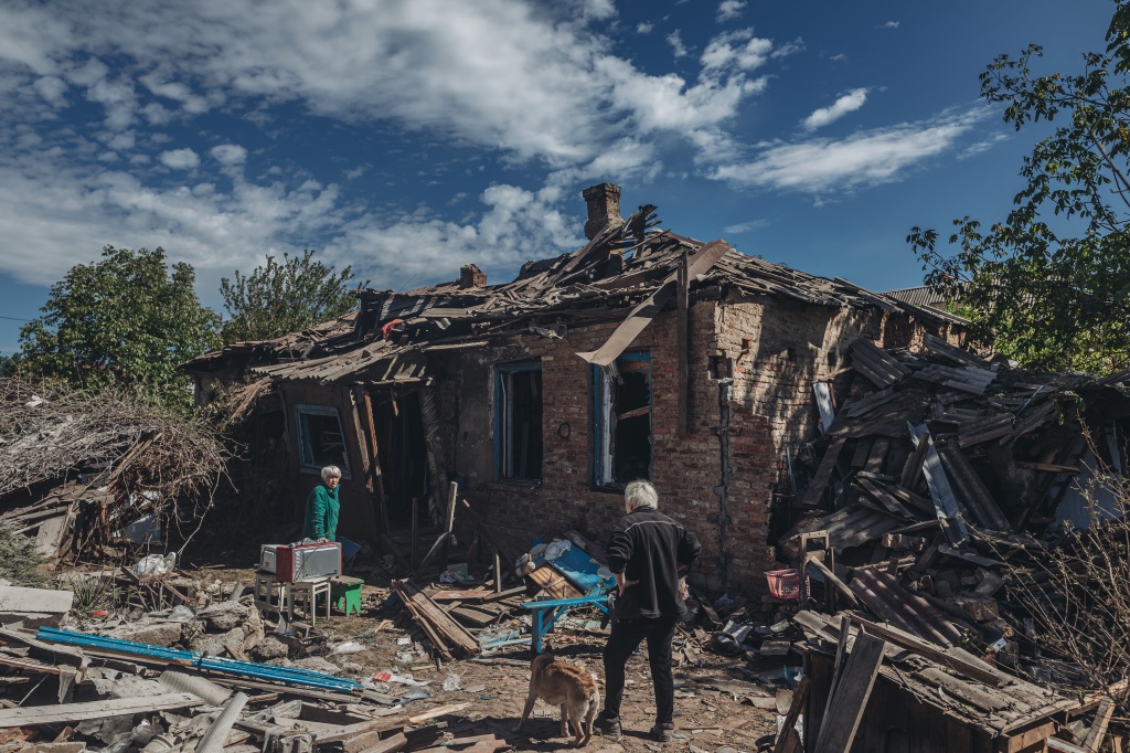 Two women stand in front of their bombed house destroyed by Russians in Bakhmut, Ukraine on May 20, 2022. 