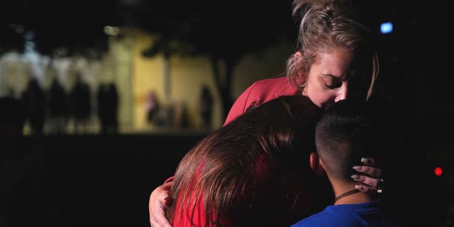 Families hug outside the Willie de Leon Civic Center where grief counseling will be offered in Uvalde, Texas, on May 24, 2022. 