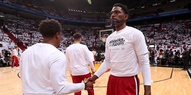 Kyle Lowry of the Miami Heat, left, shakes hands with Udonis Haslem prior to Game 5 of the 2022 NBA Eastern Conference finals against the Boston Celtics May 25, 2022, at FTX Arena in Miami, Fla.  