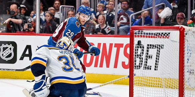 Colorado Avalanche center Nathan MacKinnon scores a third-period goal past St. Louis Blues goaltender Ville Husso for his third goal of the game in Denver on May 25, 2022.