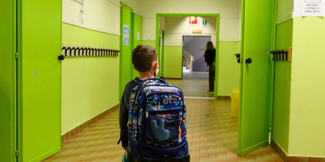 A primary school child goes to the bathroom to wash his hands on her first day of school on September 15, 2020.