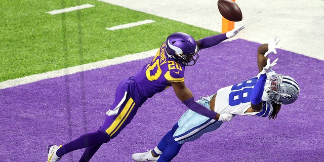 CeeDee Lamb #88 of the Dallas Cowboys pulls in a touchdown pass against Jeff Gladney #20 of the Minnesota Vikings during their game at U.S. Bank Stadium on November 22, 2020, in Minneapolis, Minnesota. 