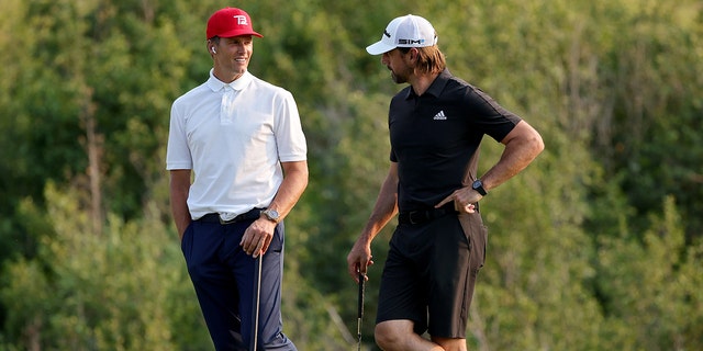 Tom Brady, left, and Aaron Rodgers meet during Capital One's The Match at The Reserve at Moonlight Basin July 6, 2021, in Big Sky, Mont. 