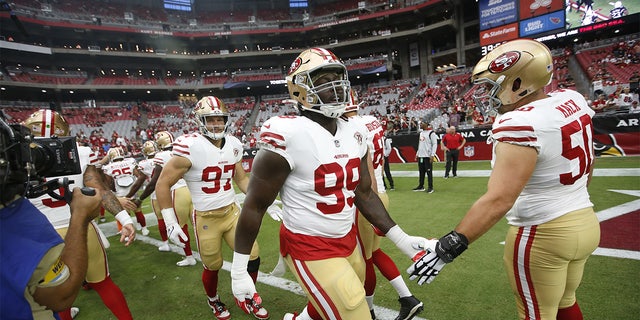 GLENDALE, AZ - OCTOBER 10: Javon Kinlaw #99 and Alex Mack #50 of the San Francisco 49ers on the field before the game against the Arizona Cardinals at State Farm Stadium on October 10, 2021 in Glendale, Arizona. The Cardinals defeated the 49ers 17-10. 